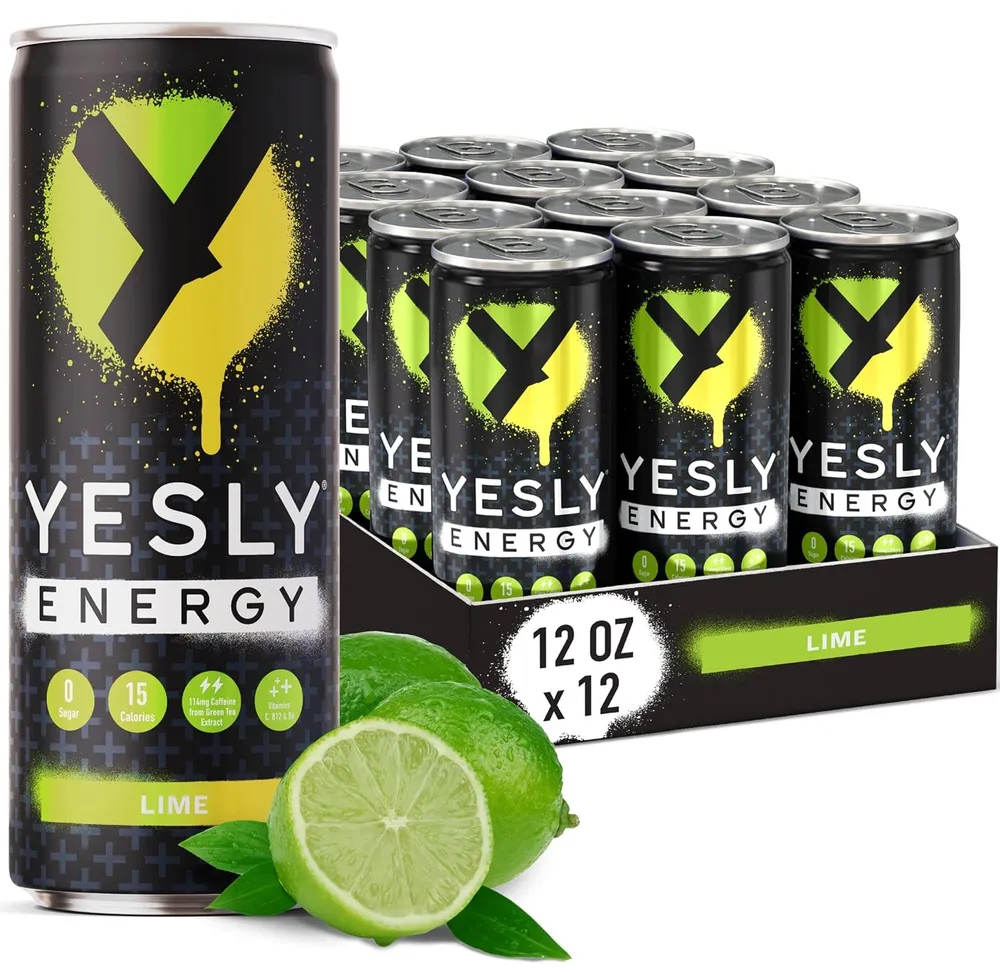 A Yesly Energy Lime can stands in front of a 12-can case, with a cut lime and green leaves at the base